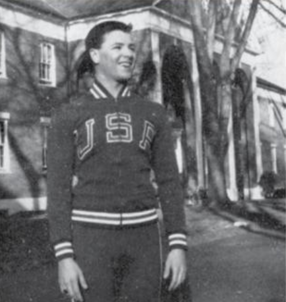 Young Philip Riker '64 P'90 pictured in his Team USA sweatsuit, stranding outside Pop Hall in 1964.