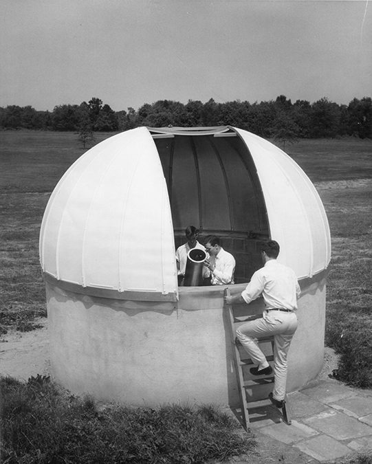 This circa 1961 image shows science master Gifford Havens H’46 ’58 and his students accessing their new observatory. Later, a door was added at ground level.