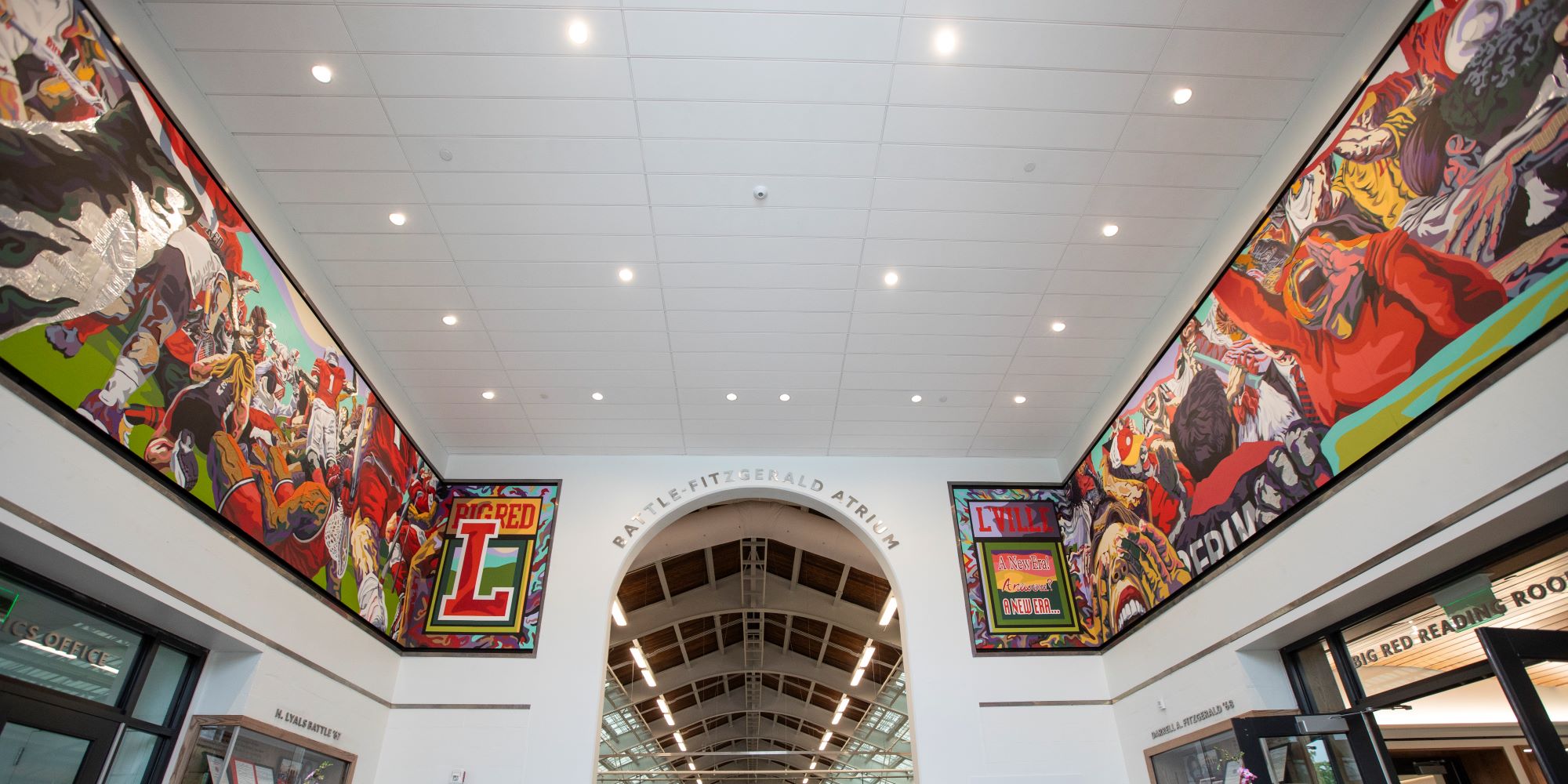 The colorful new mural hangs high around the Battle-Fitzgerald Atrium in Tsai Field House