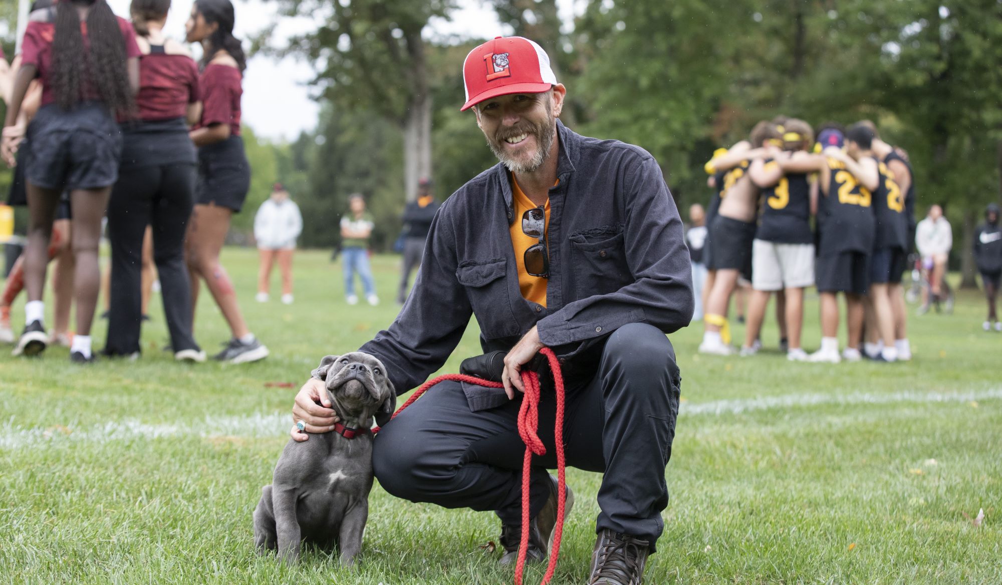 Dean of Students Blake Eldridge '96 and Larrie the bulldog.