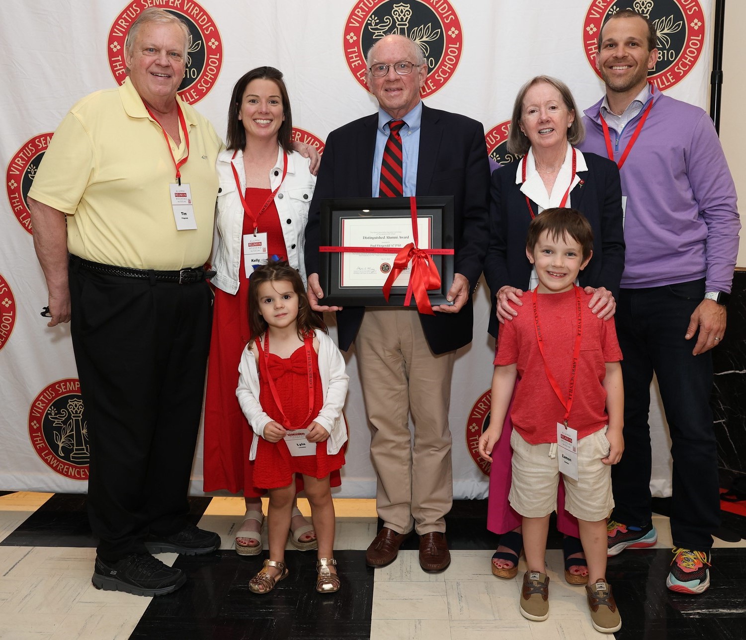 Paul Fitzgerald '67 P'03 and his family posed for a photo with Paul holding his Distinguished Alumnus Award certificate in June at Alumni Weekend 2024.