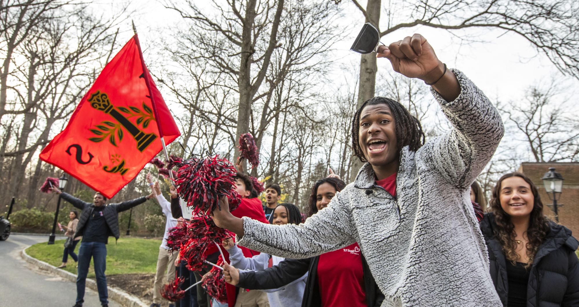 Students wave pom-pons and flags while cheering on admitted students in front of the Kirby Arts Center during Discovery Days.