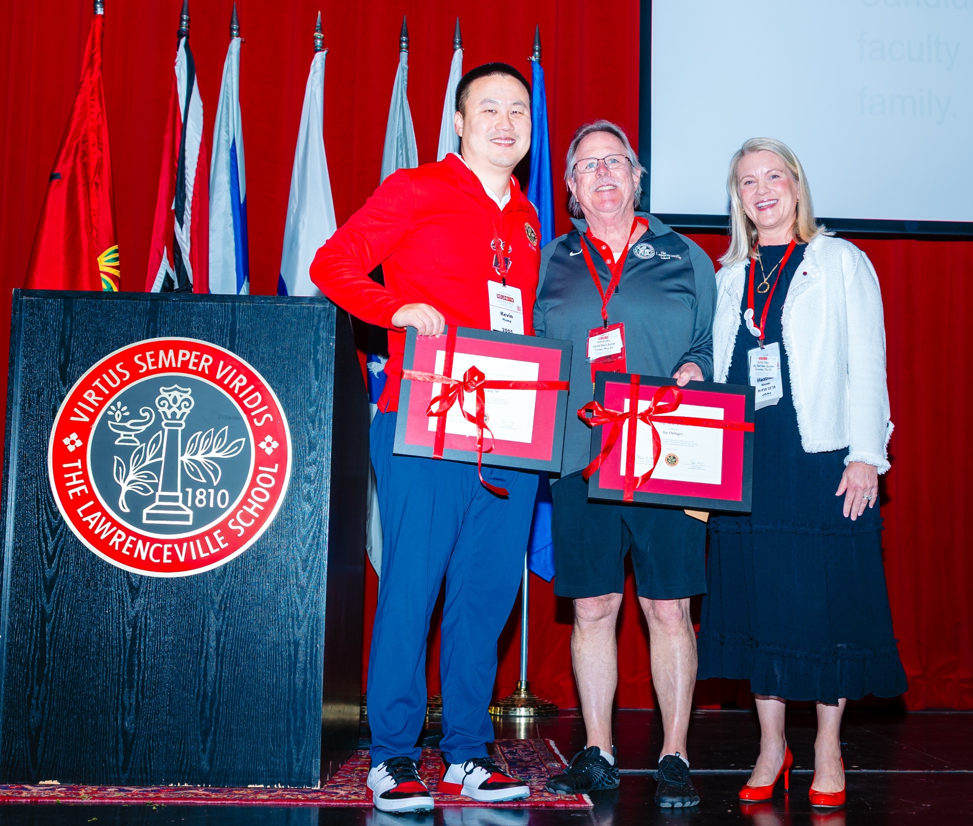 Kevin Huang and Jay Ottinger accept their framed Big Red Award certificates from Alumni Association president Heather Elliott Hoover.