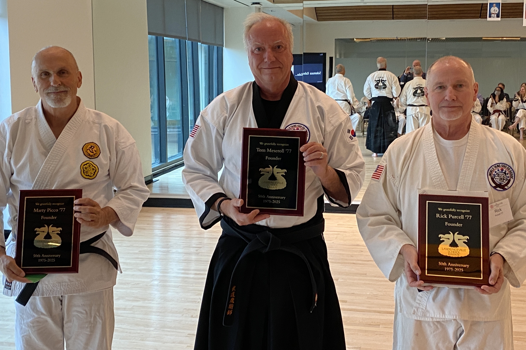 Founders Marty Picco ’77, Rick Purcell ’77, and Tom Meseroll ’77 holding the plaques they received from today's Karate Club recognizing their efforts to found the club.